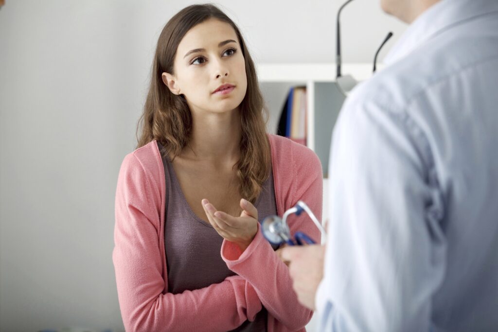Woman at a medical exam speaking to a doctor