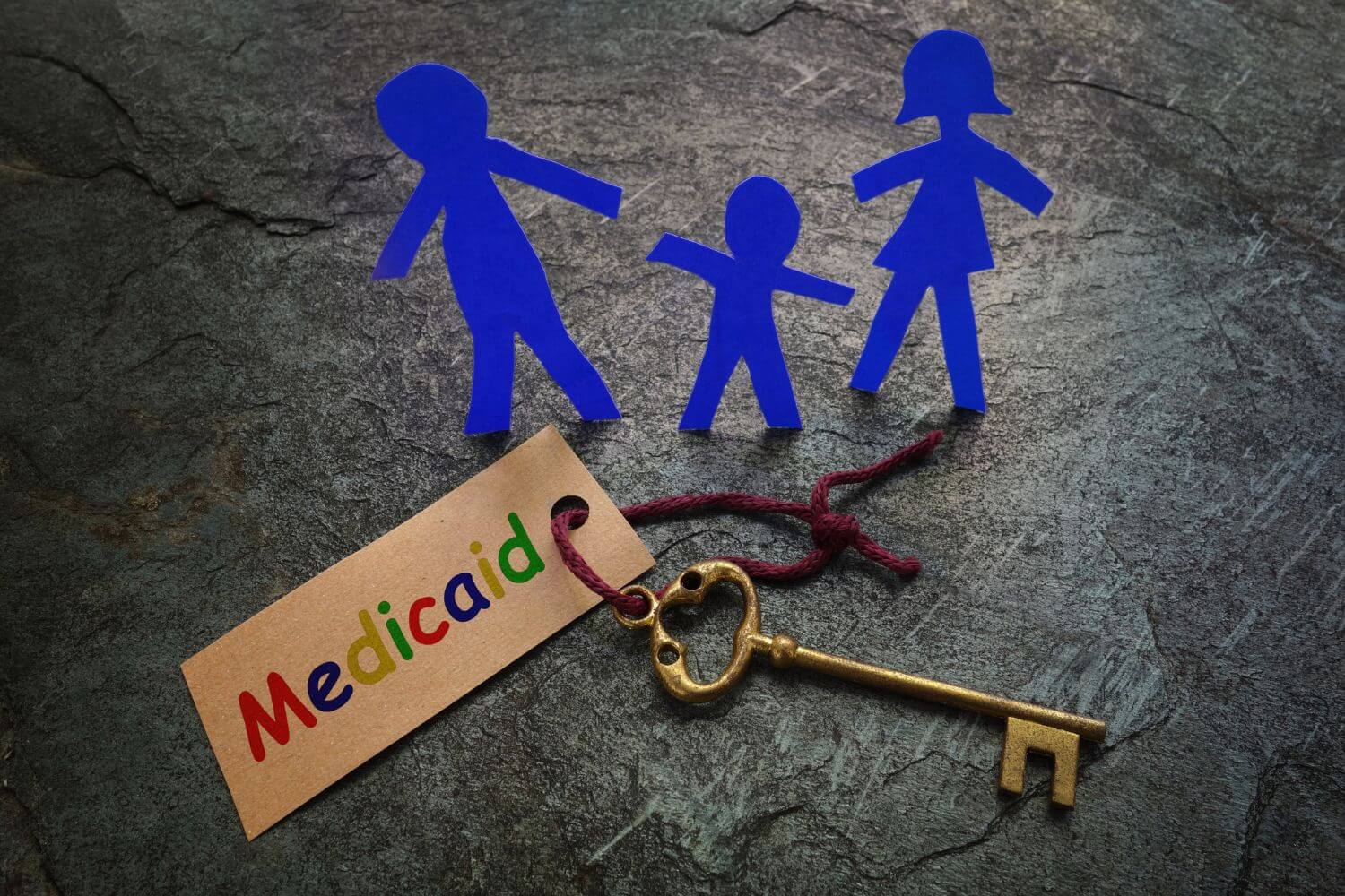 paper family with key and colorful medicaid tag