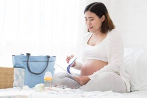woman packing her hospital bag and getting her birth plan prepared
