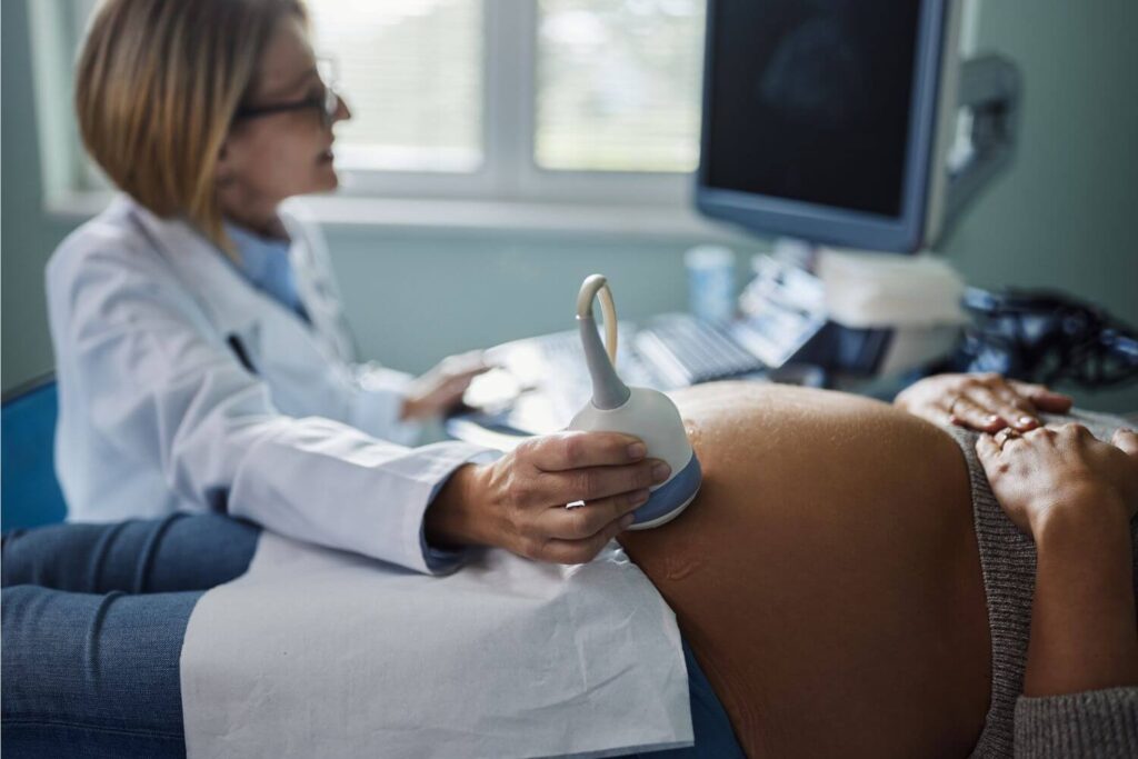 Pregnant woman undergoing an ultrasound at a pregnancy help center