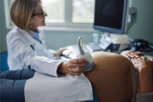 Pregnant woman undergoing an ultrasound at a pregnancy help center