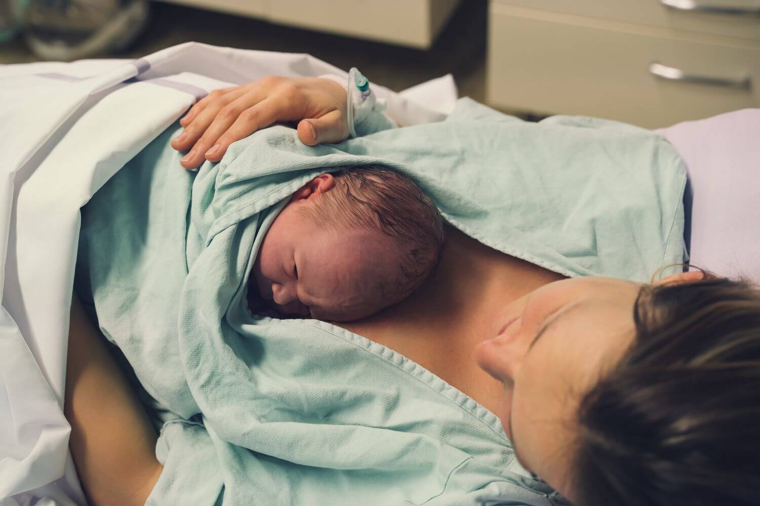Mother experiencing skin to skin contact with her newborn baby