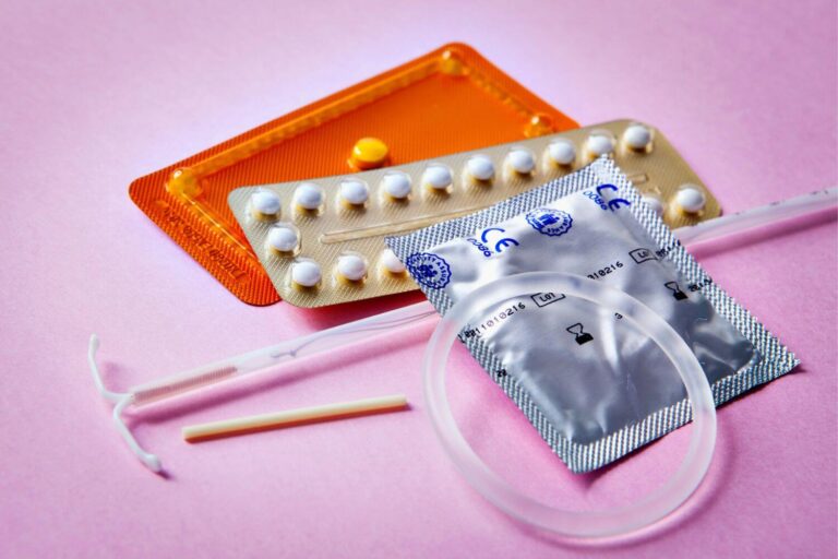 Various methods of birth control on a purple background