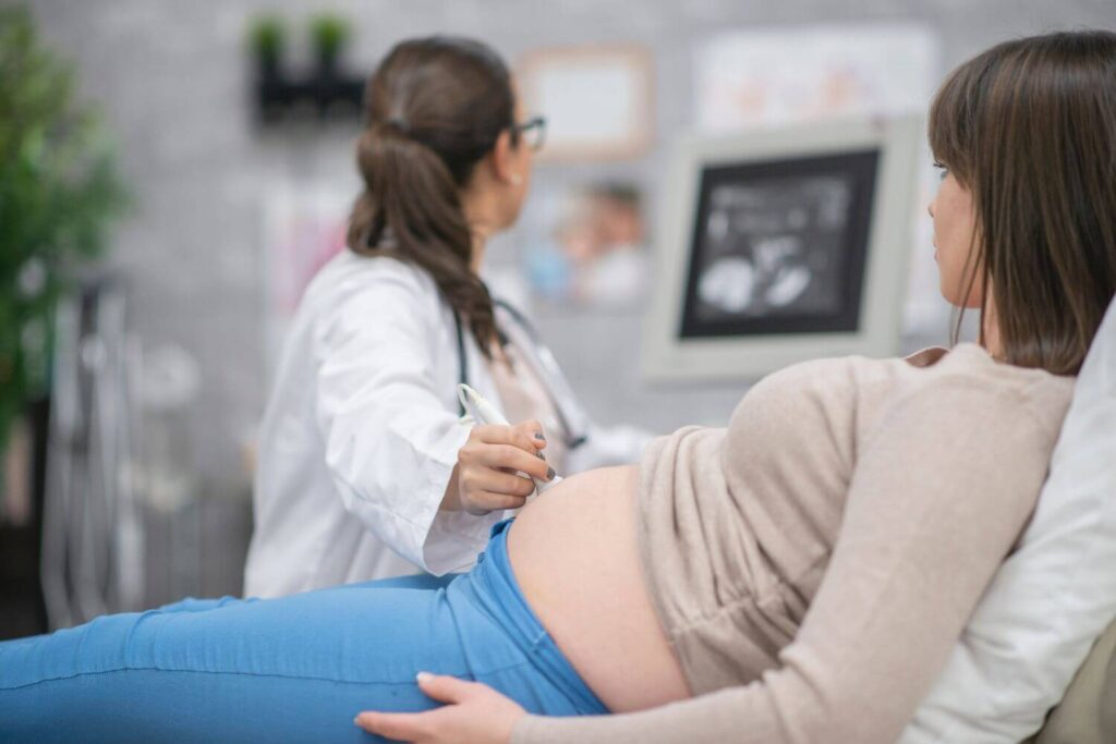 Woman with a high risk pregnancy during an ultrasound at a doctor's office