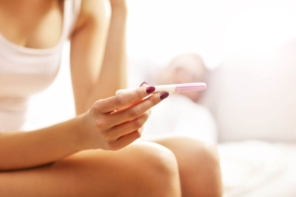 Woman holding a pregnancy test