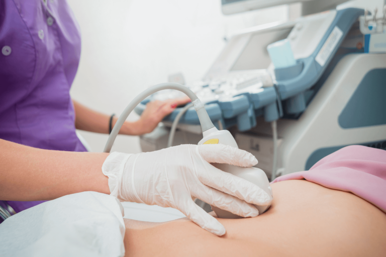 pregnant woman undergoing an ultrasound at the doctors office