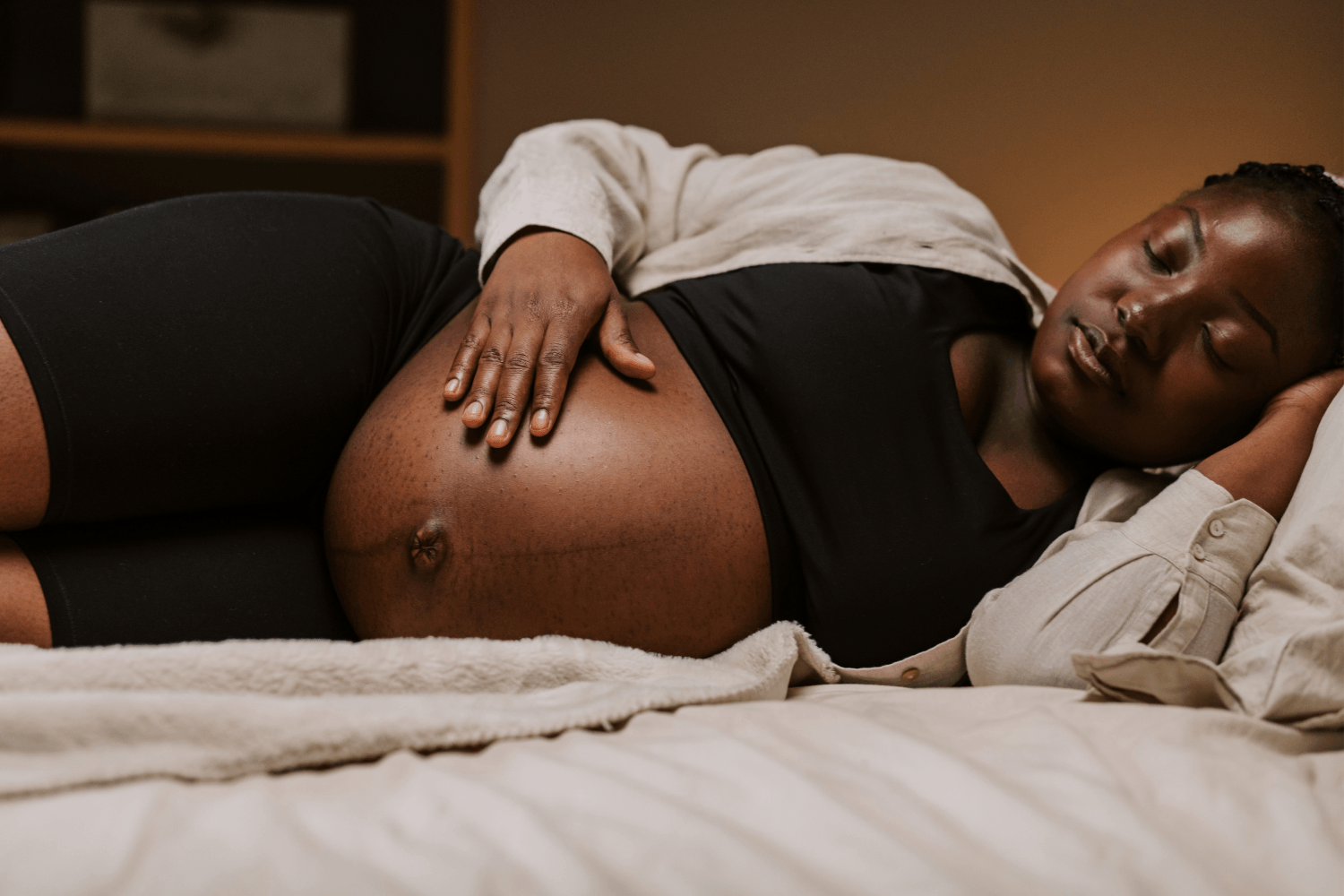 pregnant woman laying and bonding with her belly