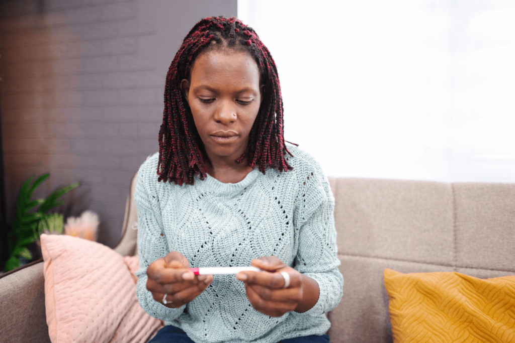 woman holding a pregnancy test