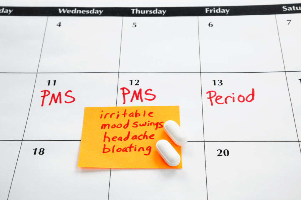 Calendar with handwritten notes regarding menstrual cycle