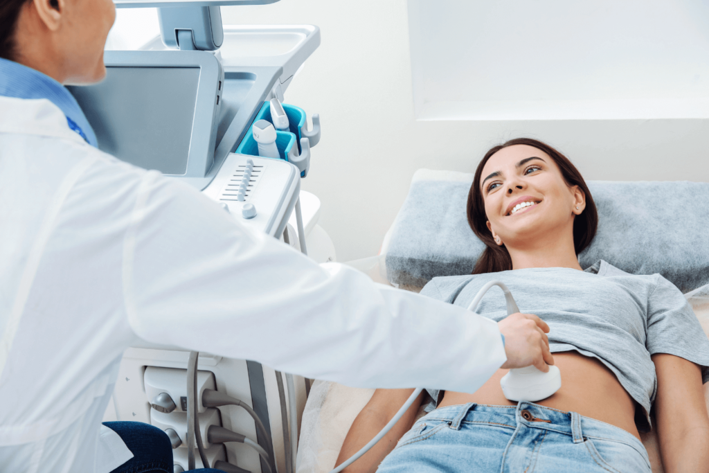 woman undergoing an ultrasound with a medical provider