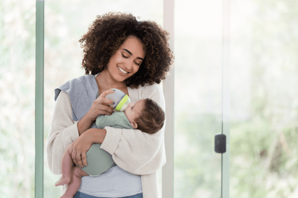First time mother holding her baby while feeding it a bottle