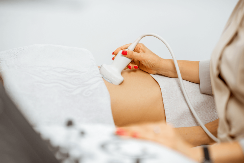 Pregnant woman undergoing an ultrasound at a medical office