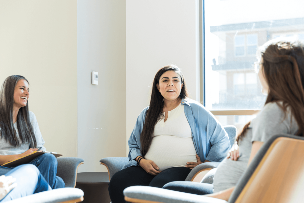 Pregnant mother speaking with a group of women