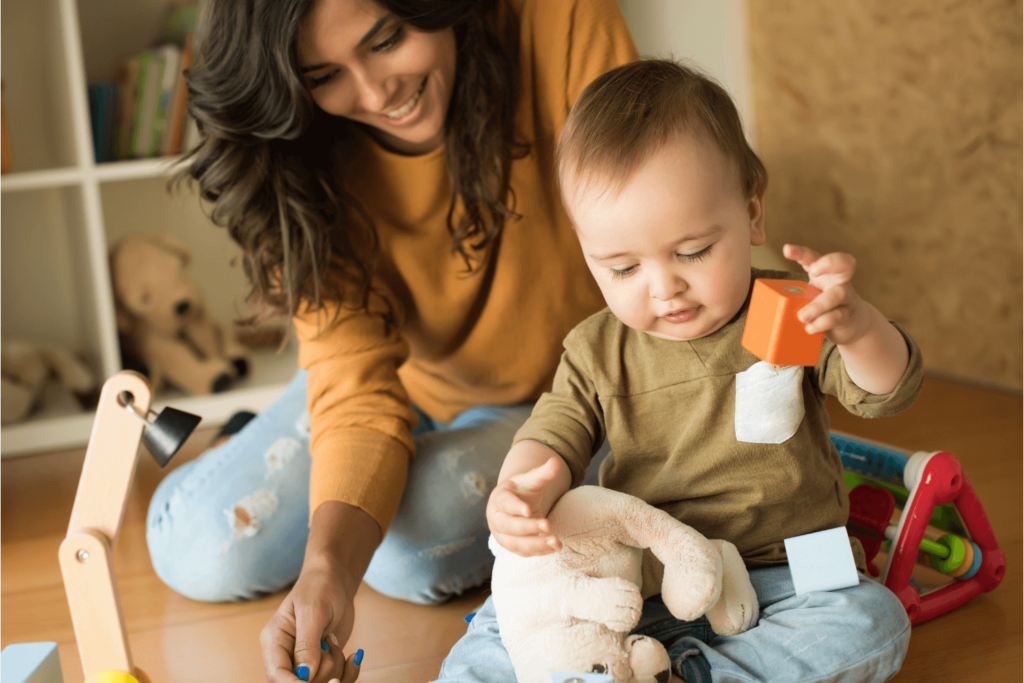 Mother playing with blocks with her baby