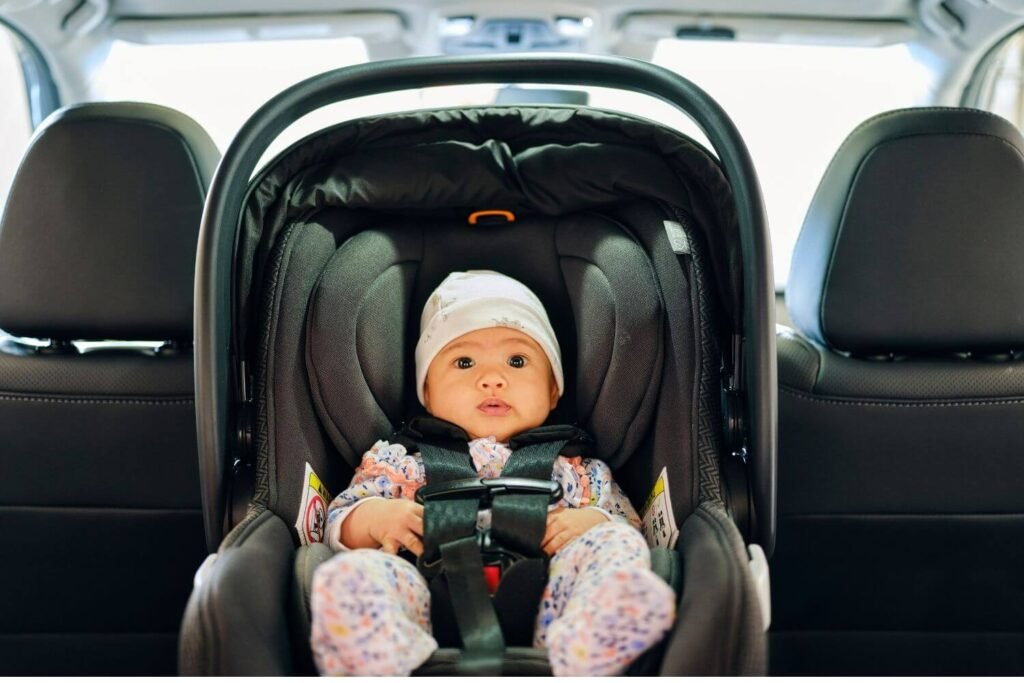 A newborn baby in a carseat