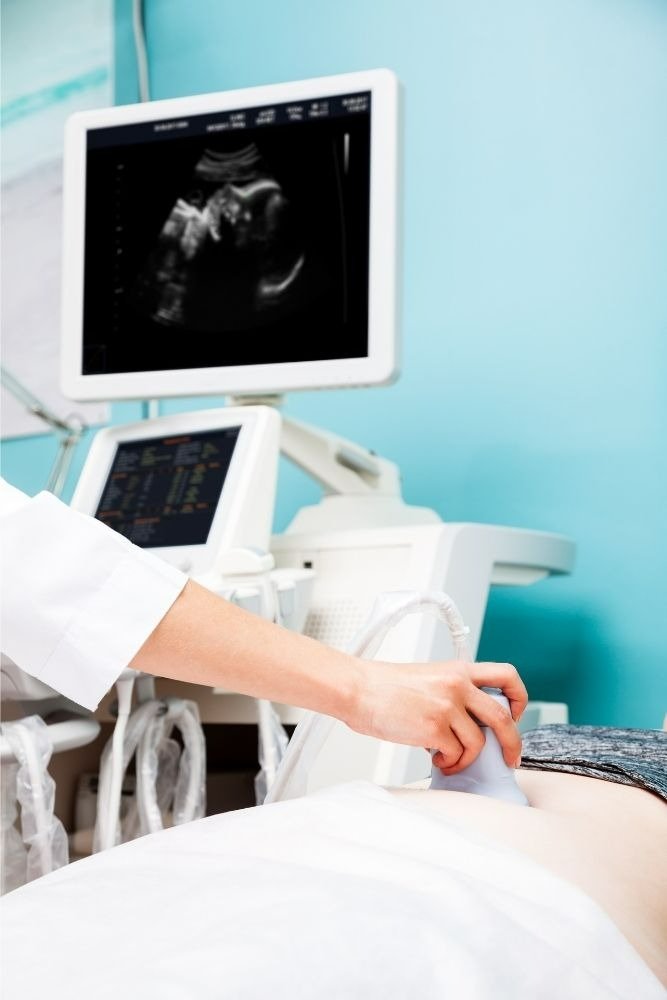 woman at a doctors office getting an ultrasound