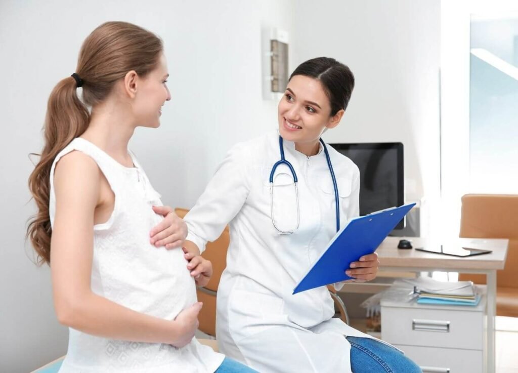 Pregnant woman during a healthcare exam with a medical professional