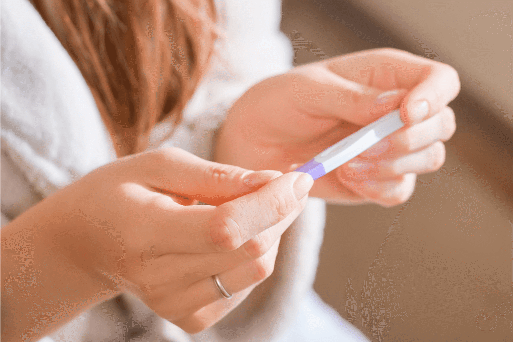 Woman holding a pregnancy test