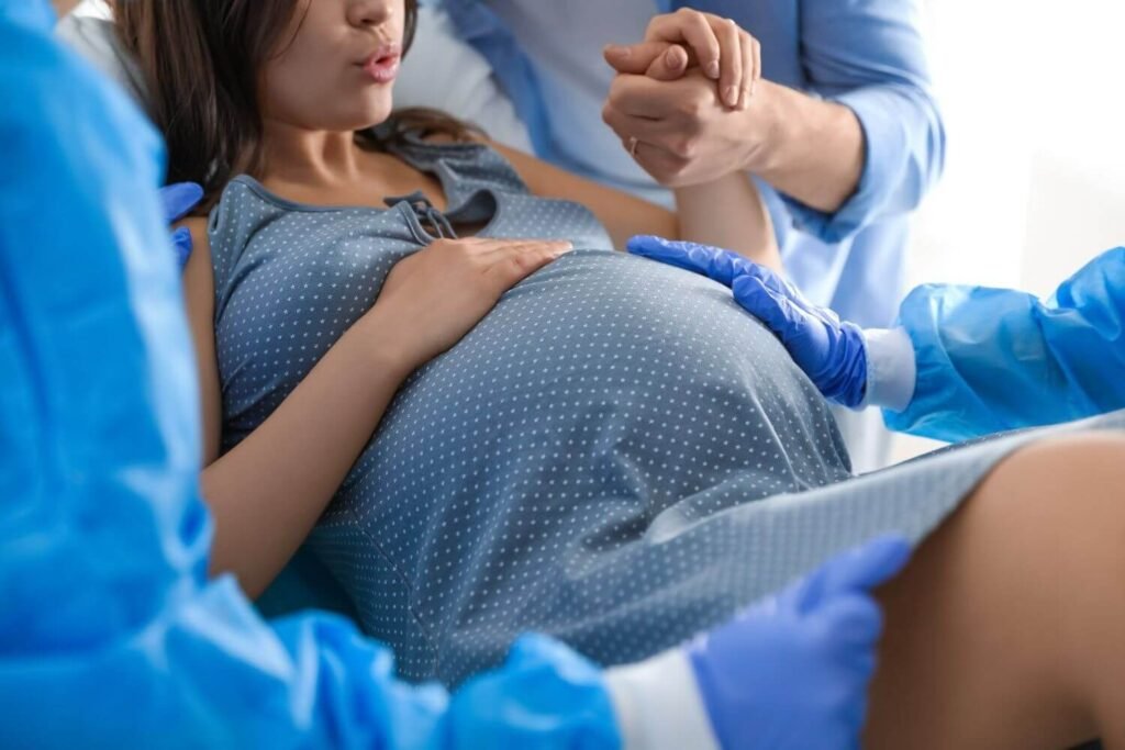 Mother at the hospital in labor, with supportive staff guiding her
