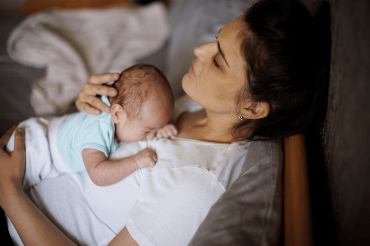Mother resting with her newborn baby on her chest