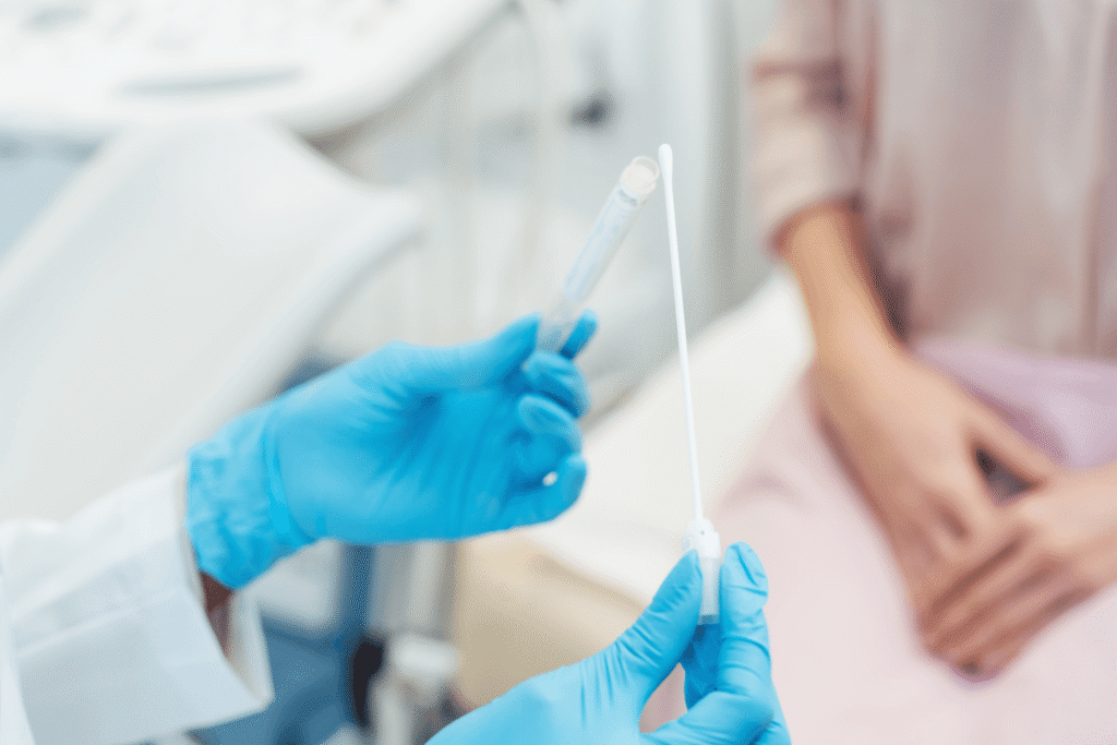Gynecologist holding a swab and test tube for STD testing during pregnancy