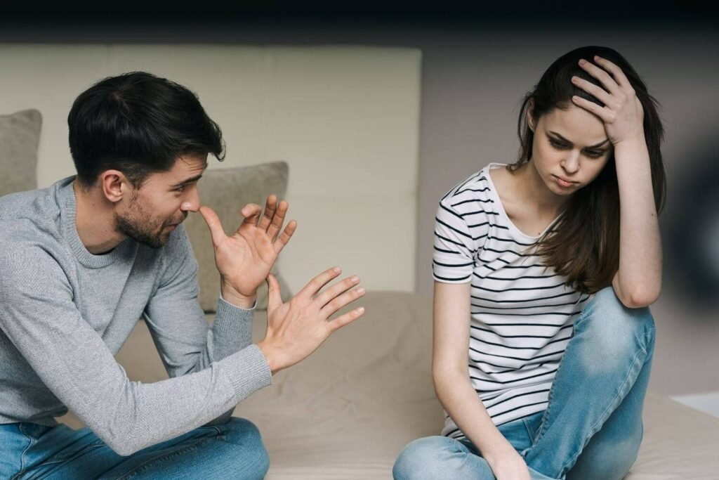 A young couple arguing on a couch